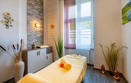 a bedroom with a bed and a sink and a window at Hotel Badehof in Bad Salzschlirf