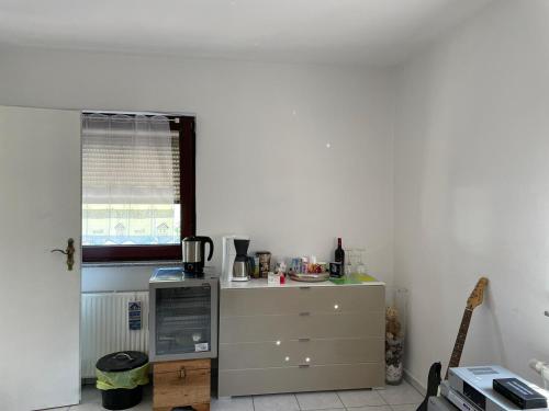 a kitchen with a dresser and a window at Vida Real Estate Feucht in Feucht