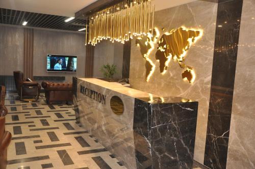 a lobby with a world map on the wall at GOLAZ SUİT OTEL in Ankara