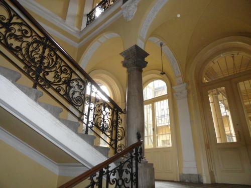 a staircase in a building with a stair railing at Boudoir Budapest Apartment in Budapest