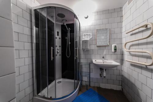 a bathroom with a shower and a sink at LAKE HOUSE in Rīga