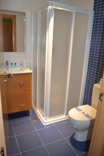 a bathroom with a shower and a toilet and a sink at The Factory Residence Hall in Segovia