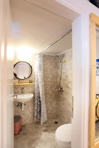 a bathroom with a toilet and a sink at Archipelagos Kimolos in Kimolos