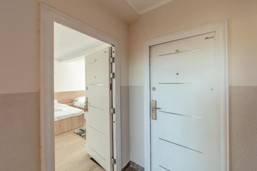 a white door in a room with a bedroom at Casa Zorilor Cluj in Cluj-Napoca