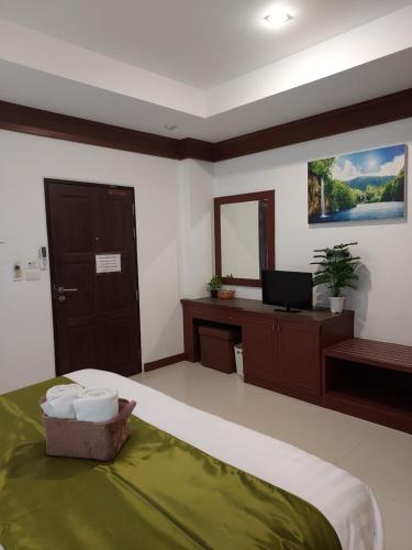 a bedroom with a bed with a television and a desk at Aromdee at Naithon Beach in Nai Thon Beach