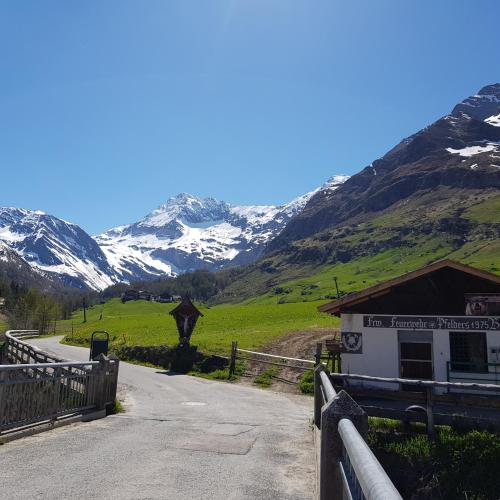 a road leading to a building with mountains in the background at Rooftop-Schenna in Schenna