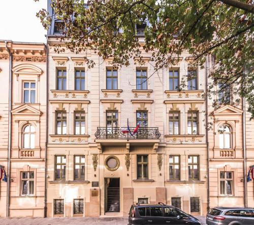 a large building with cars parked in front of it at Liebeskind Boutique Hotel Old Town in Kraków