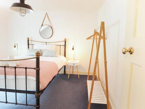 a bedroom with a bed and a mirror at Harbourside in Porthmadog