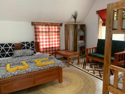 a bedroom with a bed with two yellow objects on it at David Crater Homestay in Lushoto