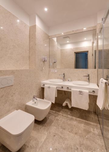 a bathroom with a toilet and a sink at BASIS APARTMENTS - Adults Only in Kyiv
