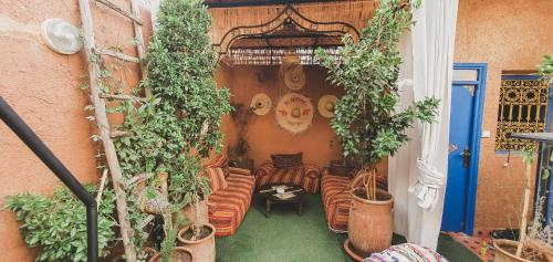 an outdoor patio with chairs and potted plants at Be Nomad in Marrakech