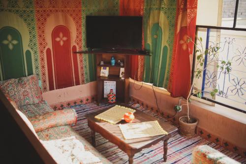a living room with a couch and a tv at Be Nomad in Marrakech