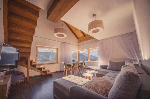 a living room with a couch and a table at ZORE JASNÁ Apartments in Demanovska Dolina