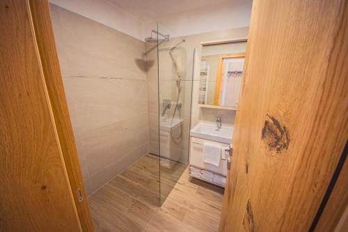a bathroom with a shower and a sink at ZORE JASNÁ Apartments in Demanovska Dolina
