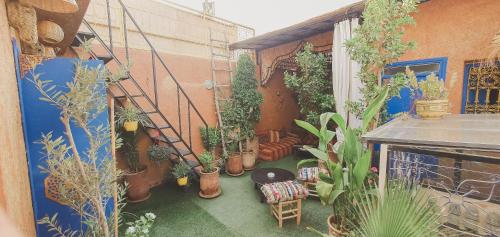 a balcony with a bunch of potted plants at Be Nomad in Marrakech