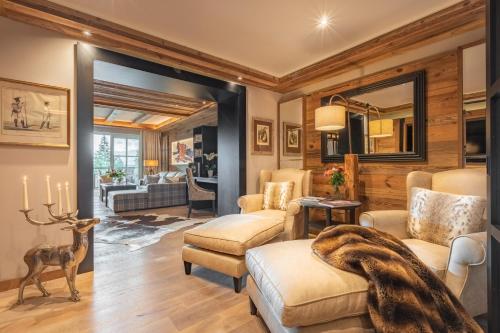 a living room with chairs and a deer in the doorway at Alpin Resort Sacher in Seefeld in Tirol