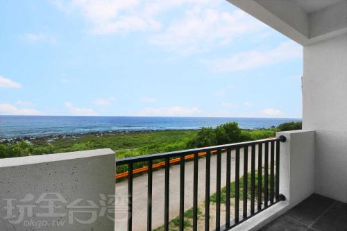 a balcony with a view of the ocean at OceanSeeker in Green Island