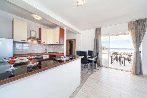 a kitchen and dining room with a view of the ocean at The View Apartments in Split