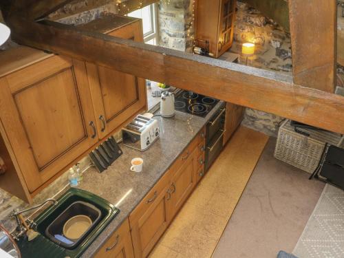 uma vista superior de uma cozinha com armários de madeira em Nuthatch Cottage em Skipton