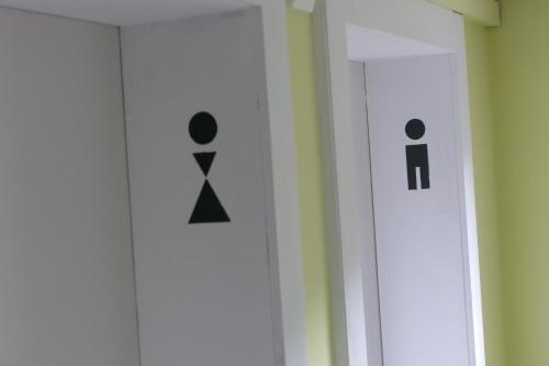 a bathroom with a toilet sign on the wall at Hotel Rigi Klösterli in Rigi Klösterli