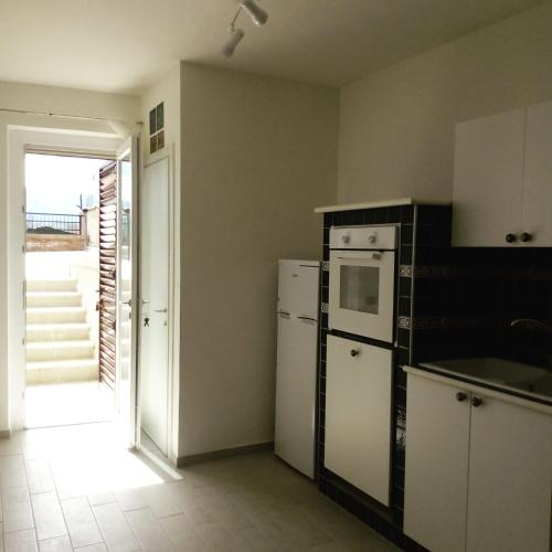 a kitchen with a refrigerator and a stove top oven at Surripe Casa Vacanze in San Lorenzello