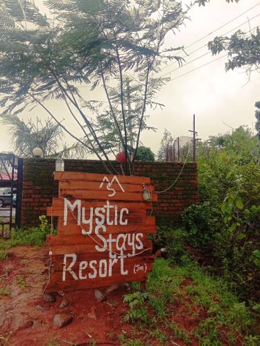 a wooden sign for a music shops resort at Mysticstays Resort in Wai