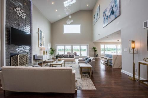 a large living room with couches and a fireplace at Lago-mar Luxury Modern Waterfront Home in Atlantic City