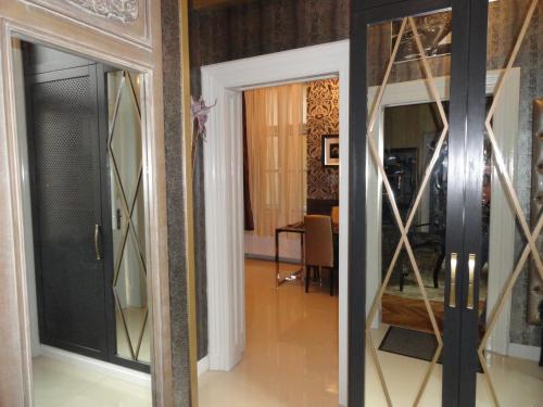 a glass door in a room with a mirror at Boudoir Budapest Apartment in Budapest