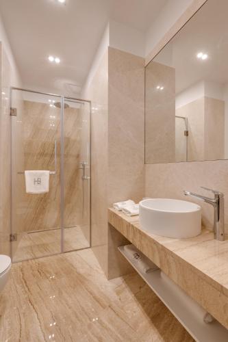 a bathroom with a sink and a shower at BASIS APARTMENTS - Adults Only in Kyiv
