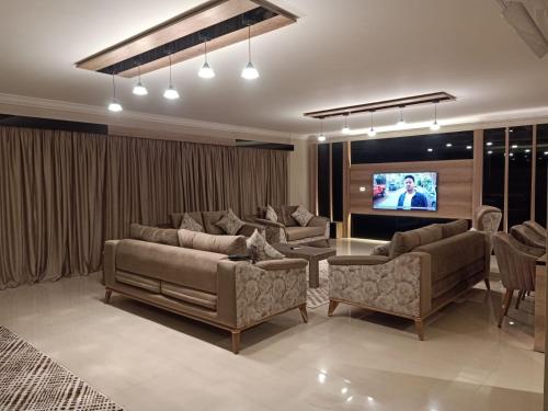 a living room with couches and a flat screen tv at Sheraton Ocean 704 - Private apartments in Cairo