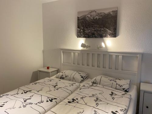 a bedroom with two beds and a picture on the wall at Ferienwohnung Buchenhöhe in Berchtesgaden