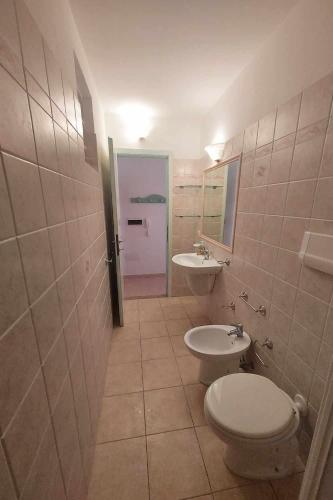 a bathroom with a toilet and a sink at La Barchetta Apartment in La Maddalena