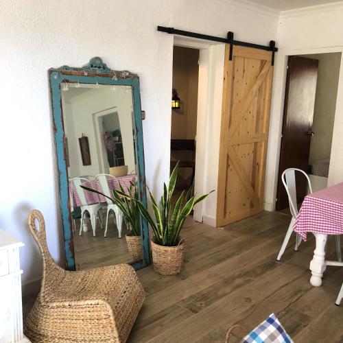 a mirror in a room with a table and a door at Charming villa near Tortosa with private pool in Tortosa