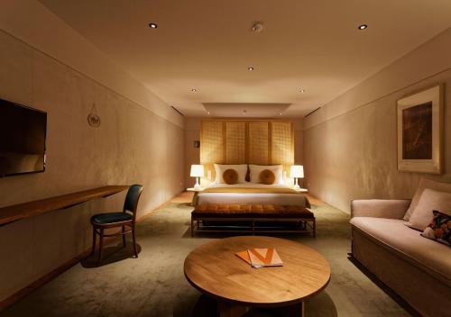 a hotel room with a bed and a table at Montebelo Vista Alegre Ílhavo Hotel in Ílhavo