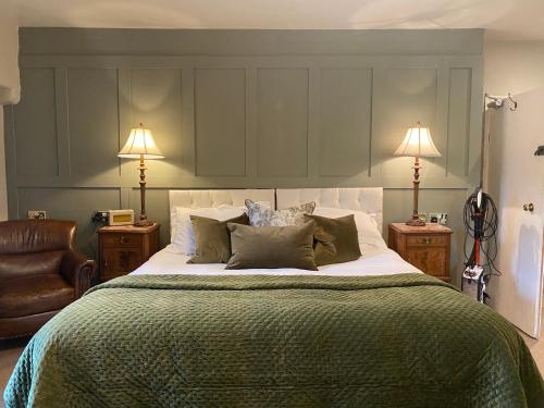 a bedroom with a large bed with two lamps at Simonstone Hall Hotel in Hawes