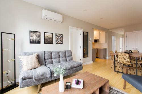 a living room with a couch and a table at Trendy Little Italy 3 Bedroom Condo Free parking in Montréal