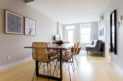 a dining room with a table and chairs at Trendy Little Italy 3 Bedroom Condo Free parking in Montréal