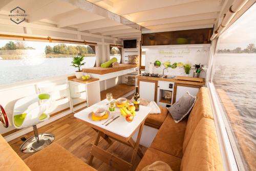 a view of the inside of a boat with a table at WOHLFÜHLBOOT Hausboot - Festlieger im Hafen Bad Saarow - WC an Bord, Dusche an Land in Bad Saarow