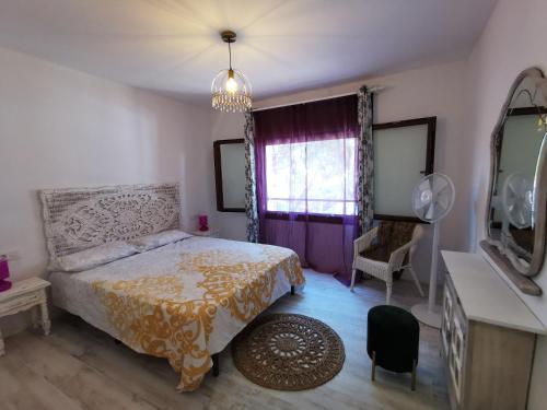 a bedroom with a bed and a tv and a window at APARTAMENTO PORT DE RODA DE BARA -ROC SANT GAIETA in Roda de Bará