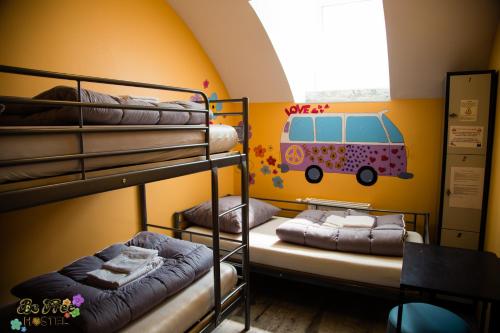 two bunk beds in a room with a van painted on the wall at BeFree Hostel - Self-Service in Vienna