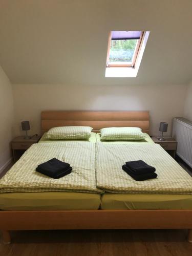 a bedroom with two beds with black towels on them at Ferienwohnung Franke DG RuheZeit am Schwarzwasser in Johanngeorgenstadt