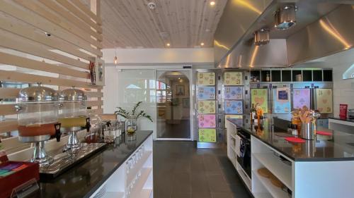 a large kitchen with a counter in a restaurant at GRAND your home with common kitchens with self check-in in Engelberg