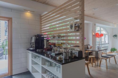 a kitchen with a counter with a counter at GRAND your home with common kitchens with self check-in in Engelberg