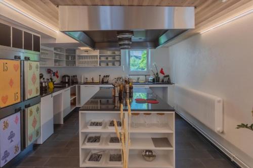 a kitchen with white counters and a large ceiling at GRAND your home with common kitchens with self check-in in Engelberg