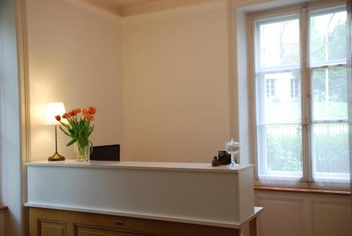 a room with a counter with a vase of flowers at The Bed + Breakfast in Luzern