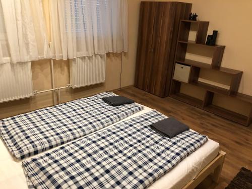 a bedroom with a bed with two pillows on it at APARTMAN 4. in Balatonalmádi