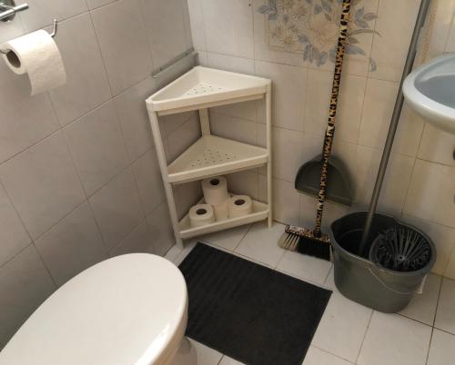 a white bathroom with a toilet and a sink at APARTMAN 4. in Balatonalmádi