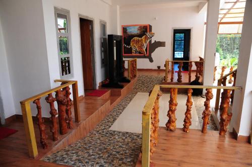 a living room with a wooden staircase and a stair case at DELIGHTFUL HOMESTAY in Sollebail