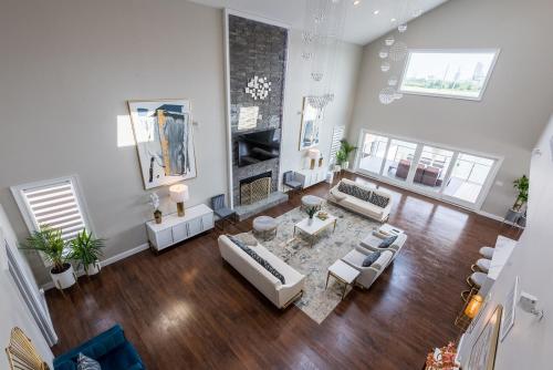 a living room with white furniture and a fireplace at Lago-mar Luxury Modern Waterfront Home in Atlantic City