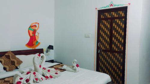 a bedroom with a bed with two stuffed animals on it at The Royal Lake View Villa in Udaipur